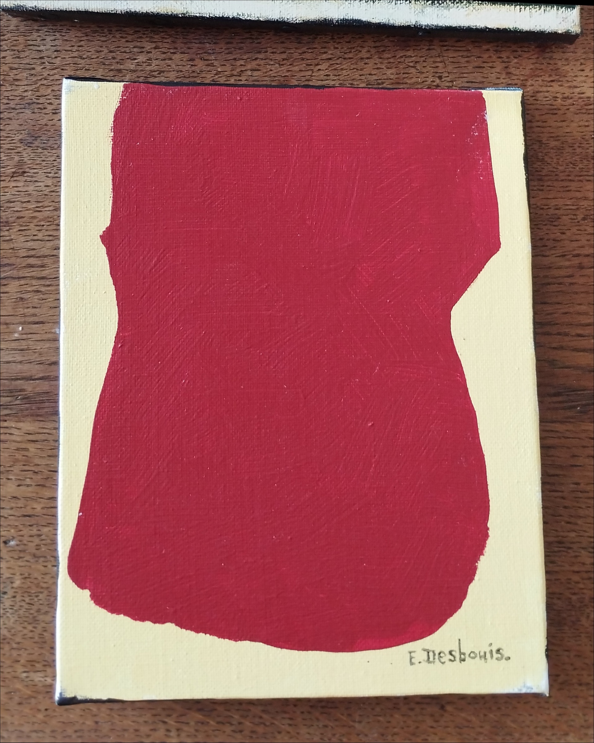 acrylique sur toile, fond jaune, grosse forme rouge. Signature en bas à droite